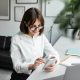 young-female-employee-using-cellphone-at-workplace-in-office-or-coworking-space-enjoying-break-at.jpg